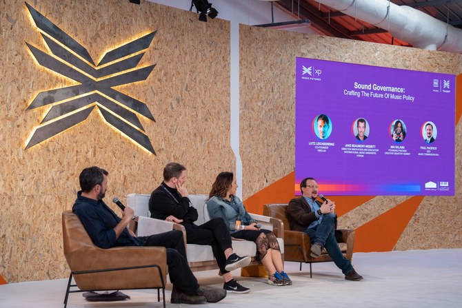 Panel discussion on music policy featuring speakers on stage during a Saudi Music Commission event.